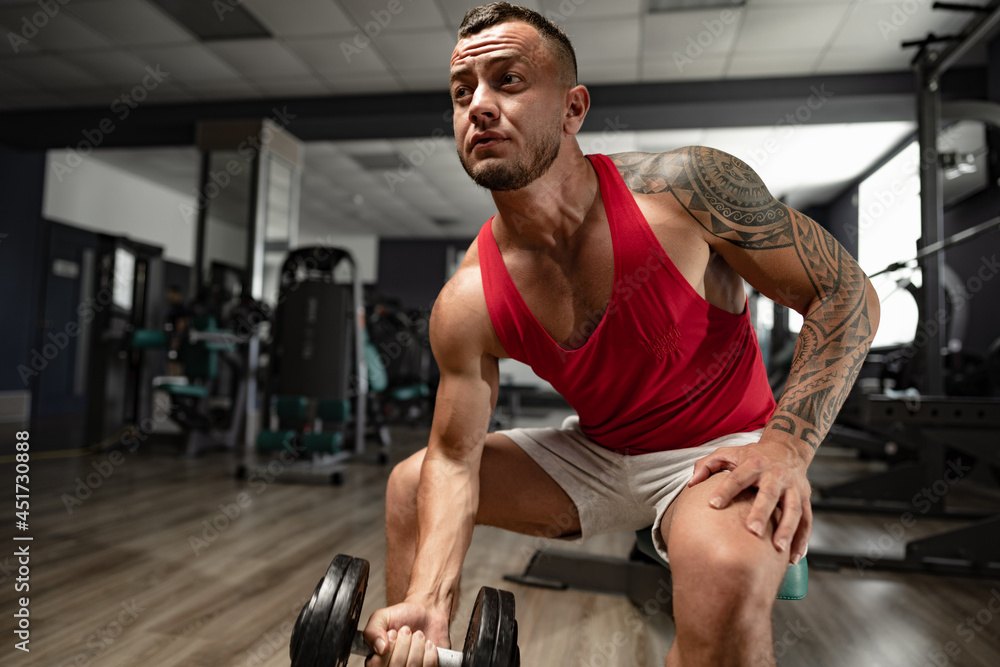 Portrait of man bodybuilder in red shirt in gym Portrait of man bodybuilder in red shirt in gym