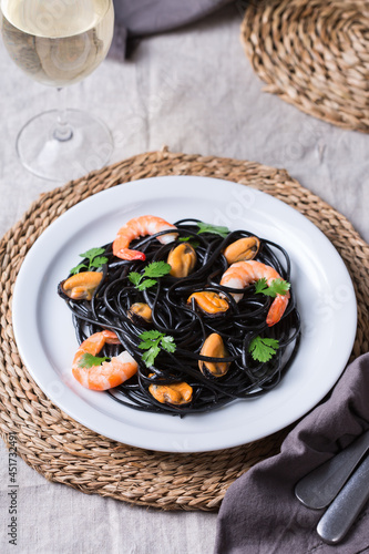 Black spaghetti pasta with seafood, shrimps, mussels and parsley