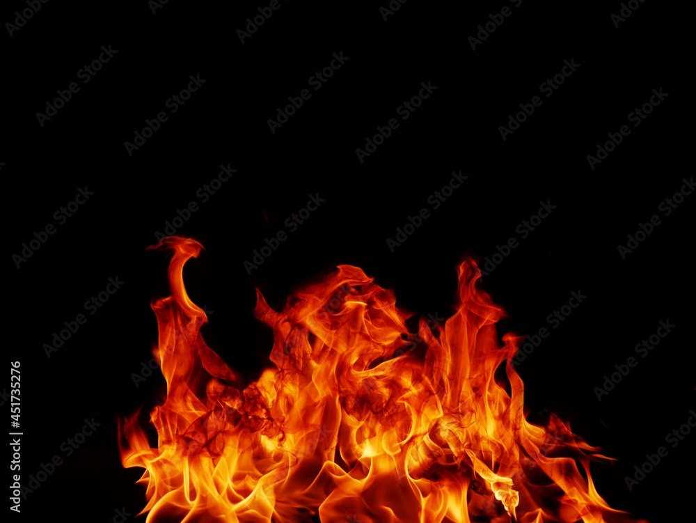 Fototapeta premium Flame meat that burns from a furnace or from cooking. dangerous feeling abstract black background .Suitable for banners or advertisements
