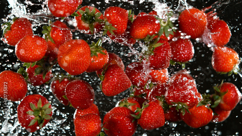 Fresh strawberries flying i...