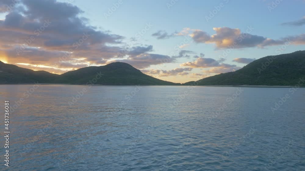 Whitsunday Island At The Coral Sea During Sundown In Queensland, Australia. wide shot Whitsunday Island At The Coral Sea During Sundown In Queensland, Australia. wide shot