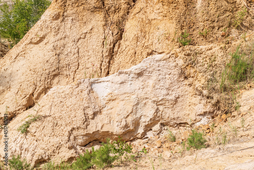 Fragment of a sandy mountain in the quarries of Russia.