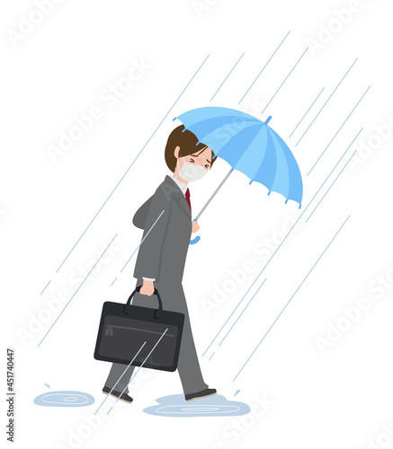豪雨の中で傘を差して歩く男性社員（マスク）
