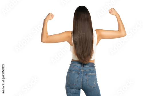 rear view of a young woman shows her biceps