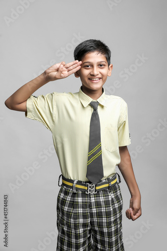 Indian child giving salute. Independence day celebration concept. photo