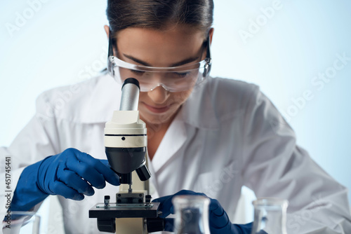 woman laboratory assistant microscope research technology science