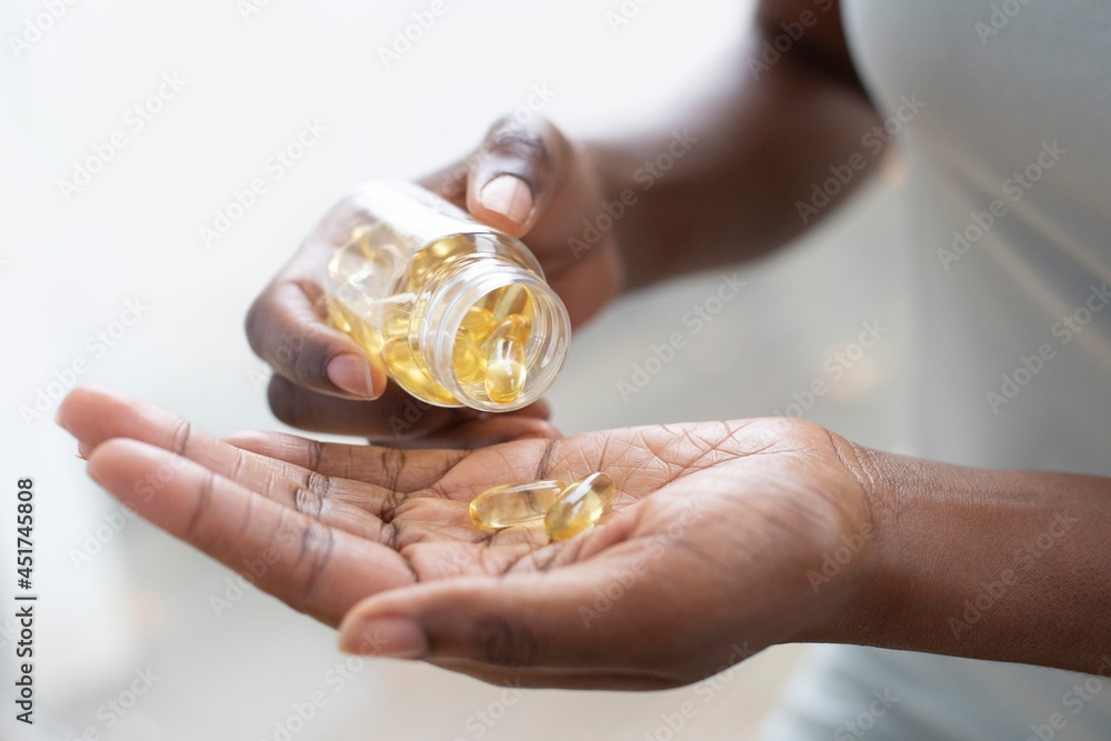 Pouring capsules into hand Pouring capsules into hand