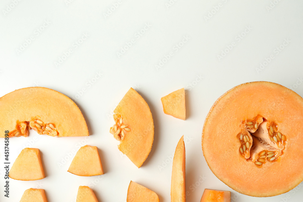 Flat lay with melon slices on white background