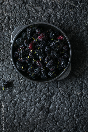 Fresh black mulberry in a wooden bowl on the wooden table. Mulberry close-up. Organik freshly harvested berries natural superfood