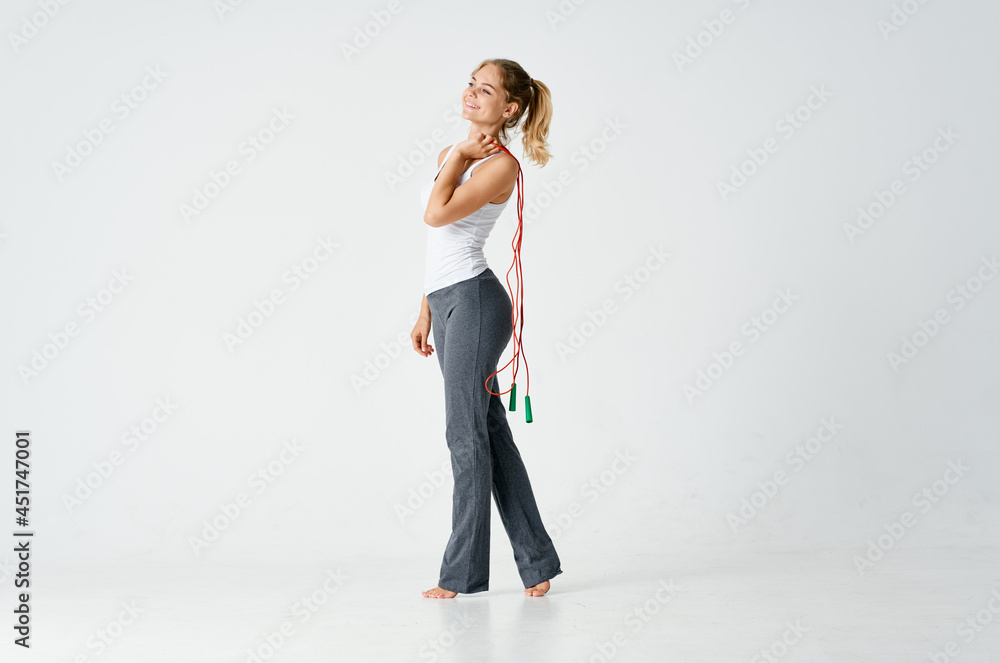 sports woman exercising with skipping rope fitness light background sports woman exercising with skipping rope fitness light background