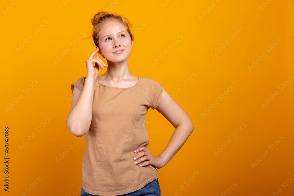 Half-length portrait of young romantic girl isolated on yellow studio background. Concept of human emotions, facial expression, youth, sales, ad. Half-length portrait of young romantic girl isolated on yellow studio background. Concept of human emotions, facial expression, youth, sales, ad.