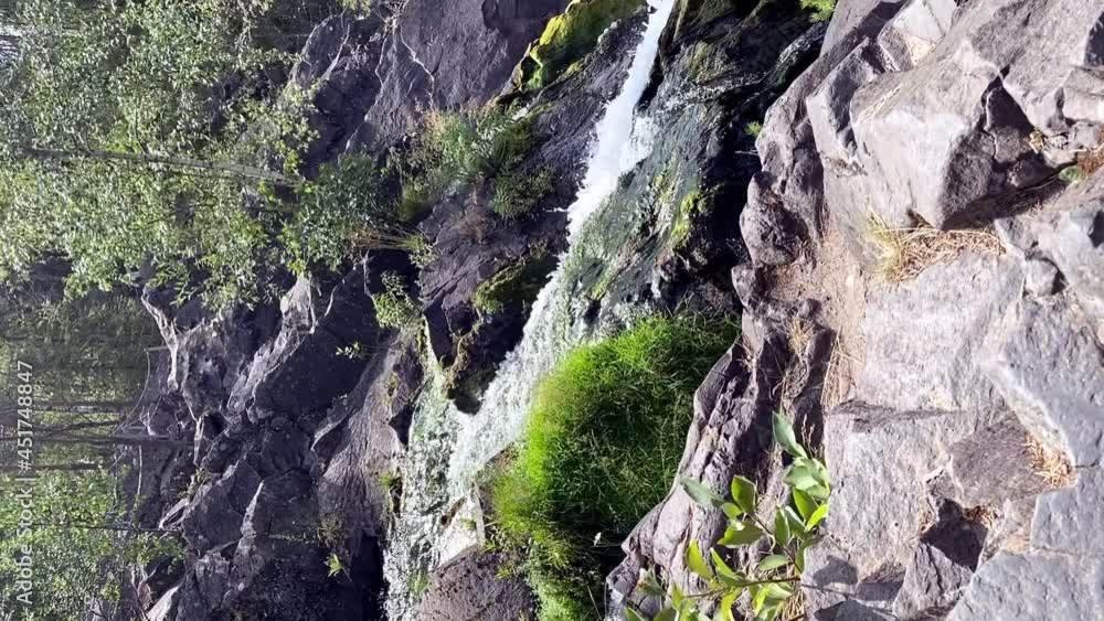 vertical video. a waterfall falls into a beautiful stormy mountain river in the Kivach nature reserve Republic of Karelia Russia. Beautiful views of nature vertical video. a waterfall falls into a beautiful stormy mountain river in the Kivach nature reserve Republic of Karelia Russia. Beautiful views of nature