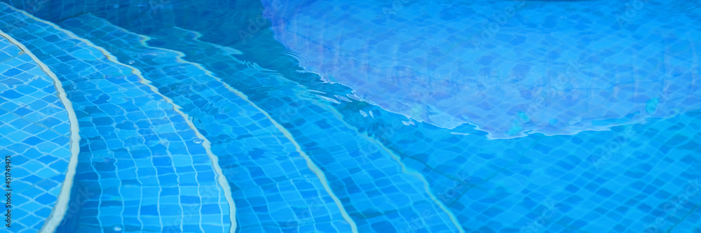 Stairs clear blue swimming pool background for cosmetic products . Banner