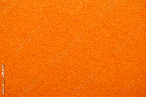 Bright orange felt, textured fabric background. Material surface. Copy space