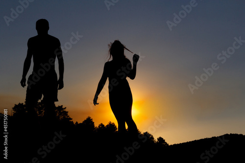 Young couple backlit at sunset. Copy space. Autumn.