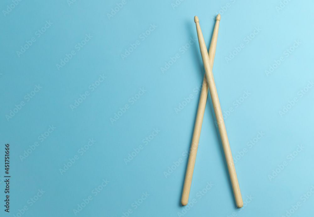 Drum sticks on a blue background. Template Copy space for text Drum sticks on a blue background. Template Copy space for text