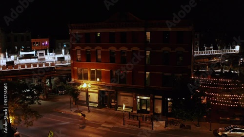 A slow dolly zoom shot of an old motel beside a rail train station in Chicago at night.