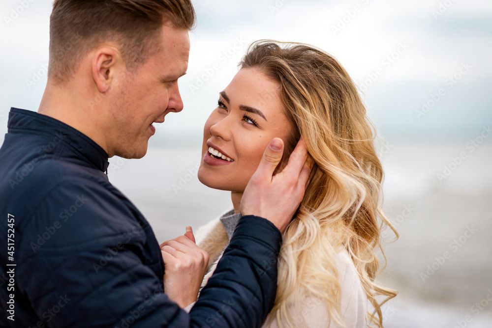 Two Young couple standing enjoying on a coast and enjoying each other.Summer,spring,autumn vacation.Closeup.