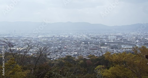 Handheld shot of Kyoto cityscape in distance from Yotsutsuji area at Fushimi Inari-taisha complex (Inariyama), Fushimi-ku, Kyoto, Japan photo
