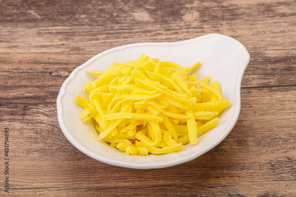 Shredded yellow cheese in the bowl Shredded yellow cheese in the bowl
