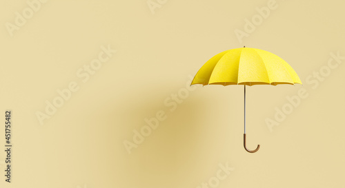 yellow umbrella on beige background with shadow photo