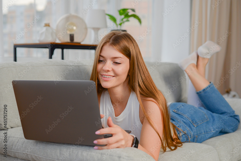 beautiful young woman in a headset communicates online with a laptop in the office. lifestyle. freelancer