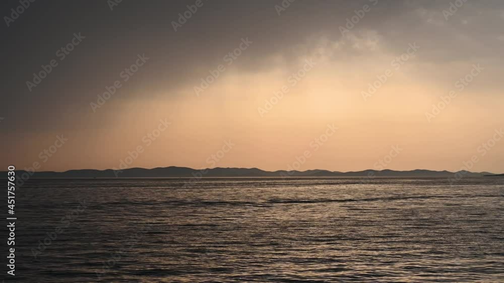 Stormy weather at the sea, view from a boat. Big waves on the sea with dramatic clouds above. Rainy summer day. Stormy weather at the sea, view from a boat. Big waves on the sea with dramatic clouds above. Rainy summer day.