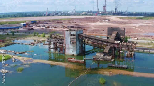 A flooded building on an industrial site. The concept of man-made disaster and environmental pollution. Aerial view