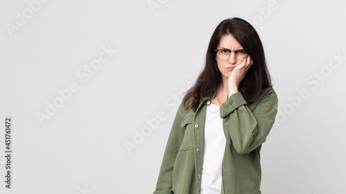 pretty woman feeling bored, frustrated and sleepy after a tiresome, dull and tedious task, holding face with hand