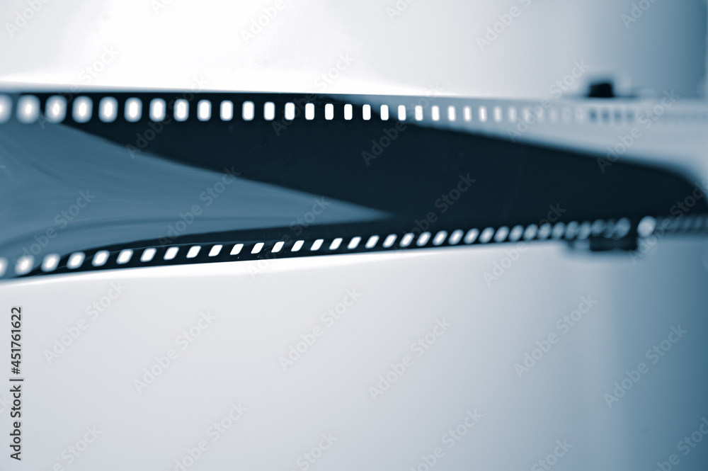 Film strip and coil silhouette.