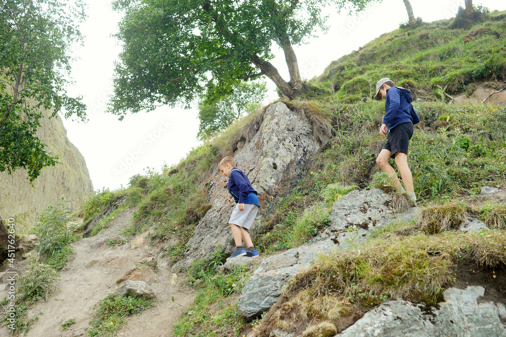 hiking in the mountains. Children travelling. Adventure. Nature. Outdoor activity. Summer 