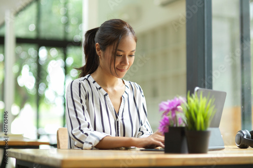 Woman using tablet, positive emotion, happy, browsing website via tablet