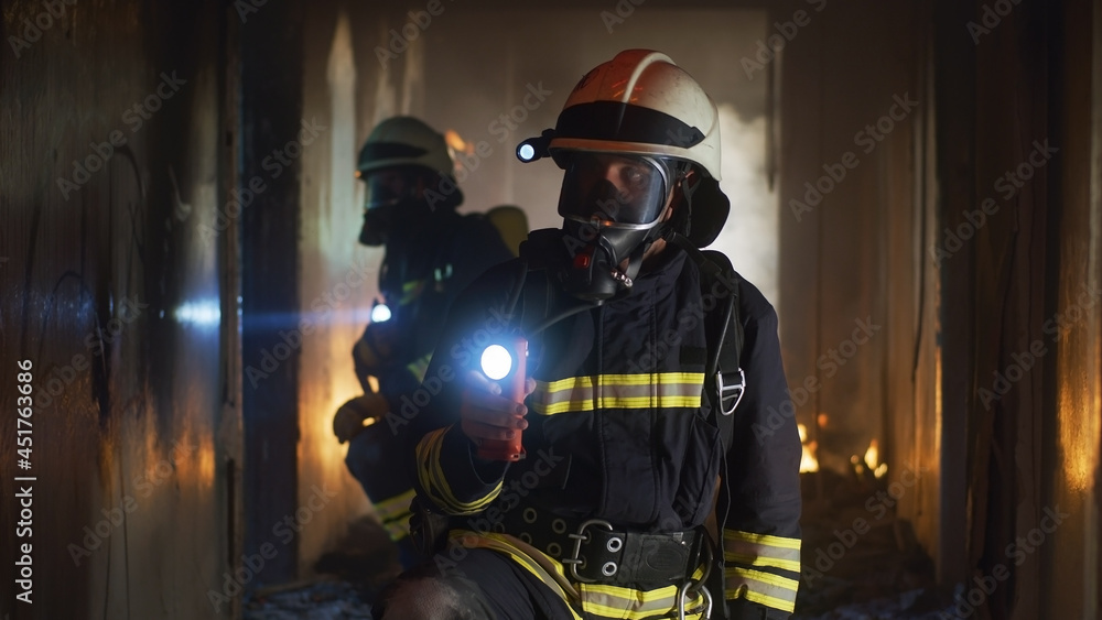 Firemen examining hallway after fire - obrazy, fototapety, plakaty 