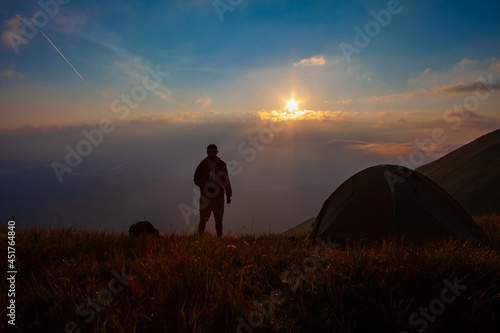 Inspirational sunrise. Man in beautiful inspiring sunrise with mountains
