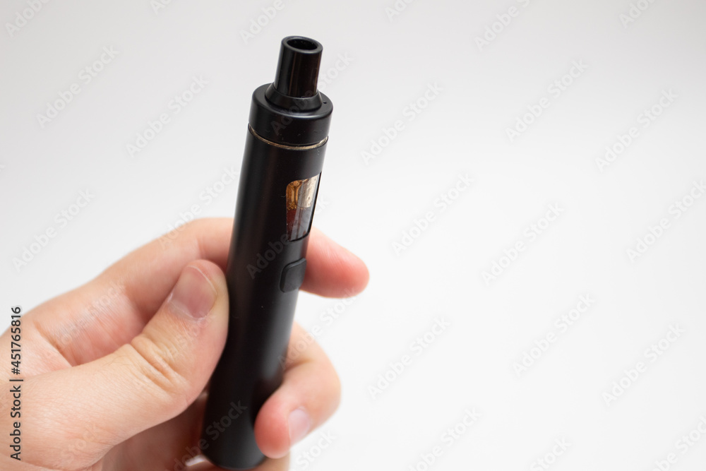 Vape device in hand. Man hand holding Electronic cigarette. Vape device in hand. Man hand holding Electronic cigarette.