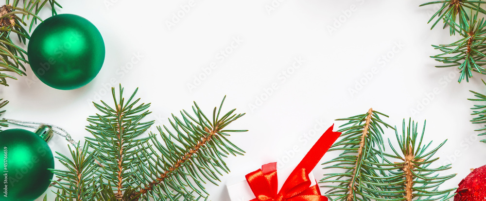 Merry Christmas and Happy Holidays greeting card, frame, banner. Christmas gifts and green decor on white background top view. New Year concept. Flat lay Merry Christmas and Happy Holidays greeting card, frame, banner. Christmas gifts and green decor on white background top view. New Year concept. Flat lay