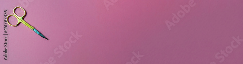 manicure scissors on a pink background. scissors close up. banner for insertion on the site
