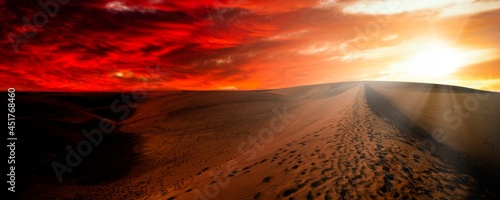 Sunset over sand dunes photo