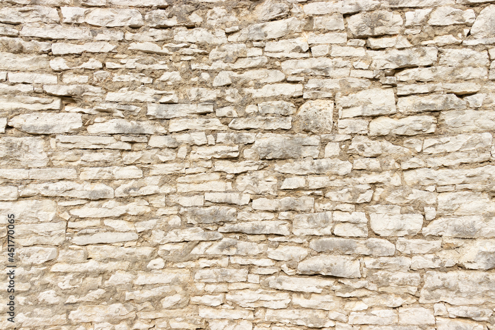 Obraz premium Large stone wall made by stacking small stone blocks