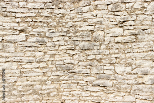 Large stone wall made by stacking small stone blocks