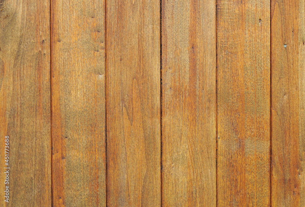 Wooden wall made of red-brown wooden panels. Background with wooden surface. Wooden wall made of red-brown wooden panels. Background with wooden surface.