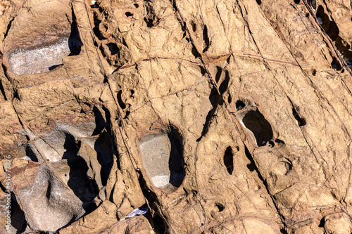 Rocks that can be seen at low tide at Melkbosstrand Cape Town, with naturally eroded visible marks caused by many years of running sea water photo