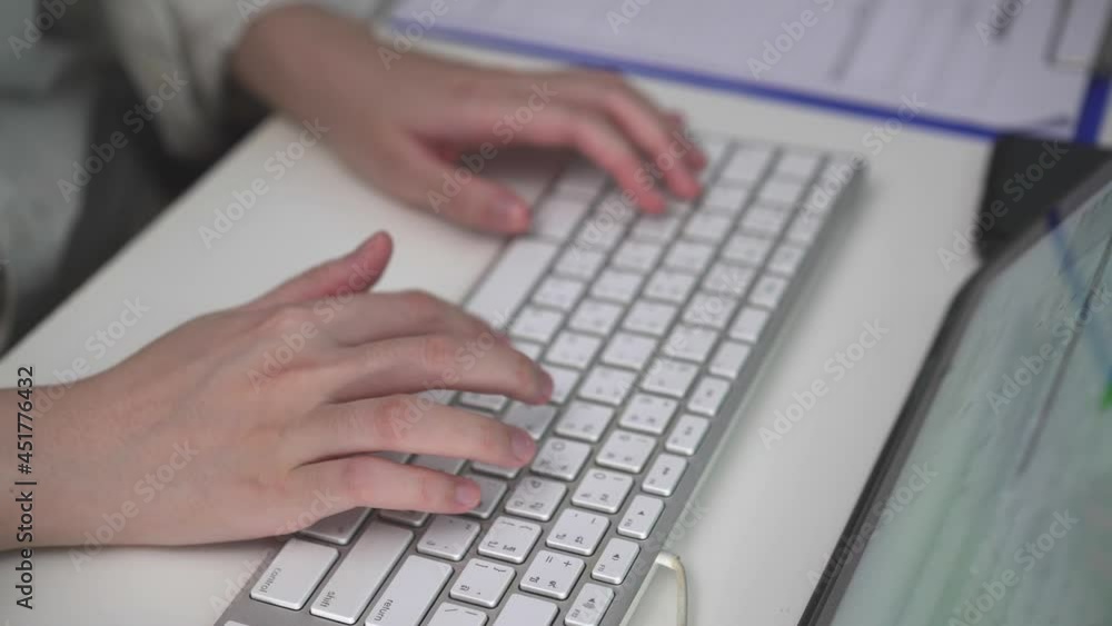 Close up female hand typing on keyboard. using digital tablet for desktop monitor. searching on website for information or business working Close up female hand typing on keyboard. using digital tablet for desktop monitor. searching on website for information or business working
