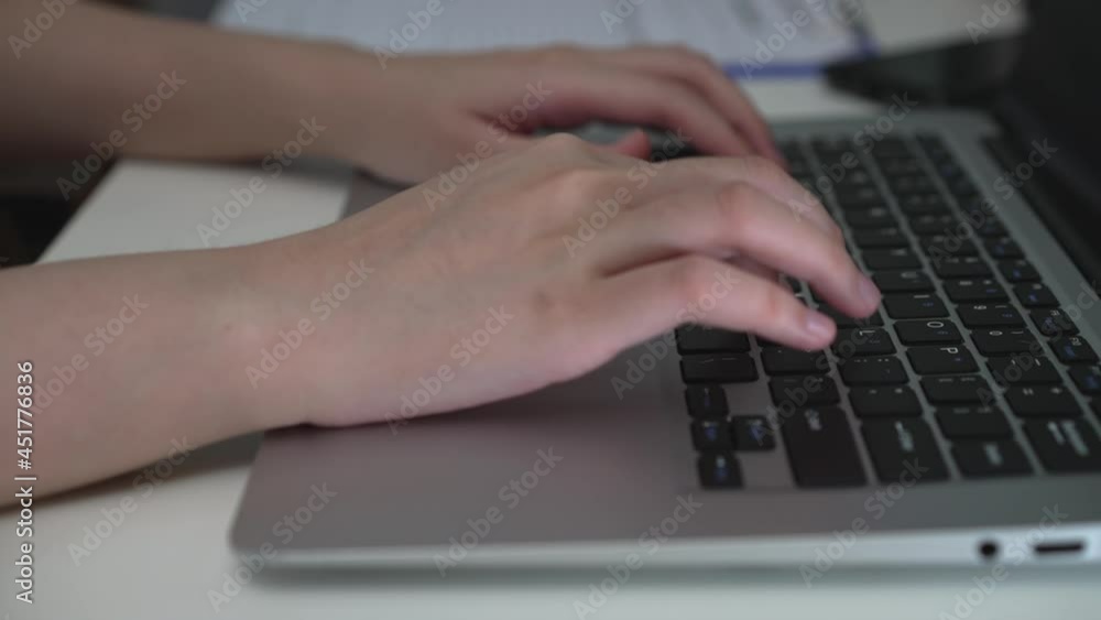 Close up female hand open laptop and typing on keyboard. searching on website for information or business working Close up female hand open laptop and typing on keyboard. searching on website for information or business working