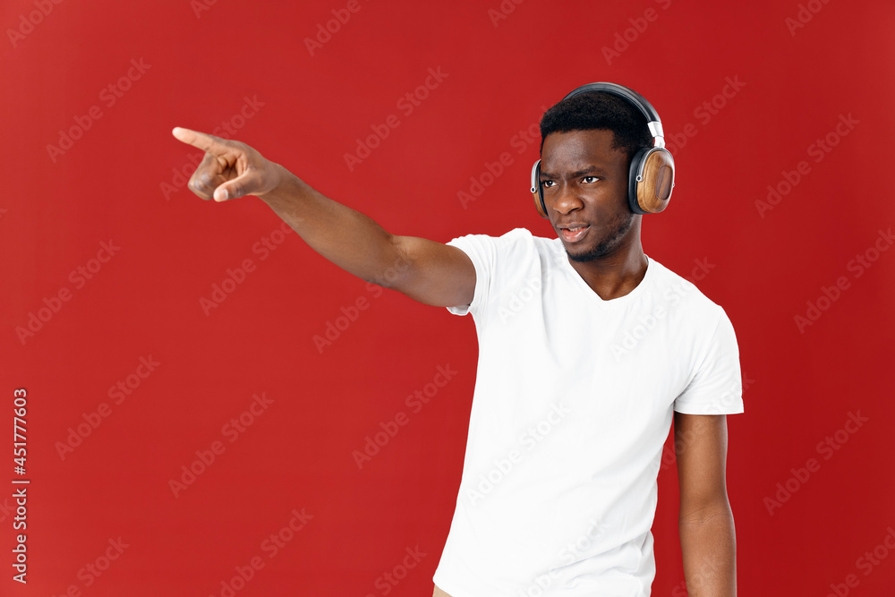 man of African appearance in headphones red background Copy Space man of African appearance in headphones red background Copy Space