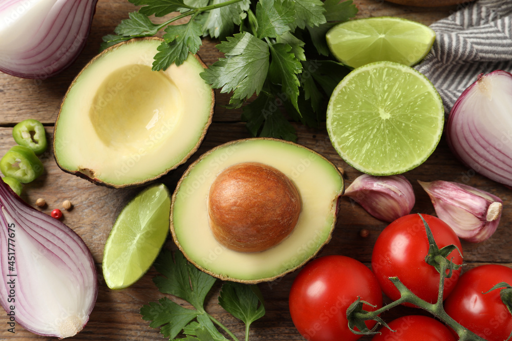 Fresh ingredients for guacamole on wooden table, flat lay Fresh ingredients for guacamole on wooden table, flat lay