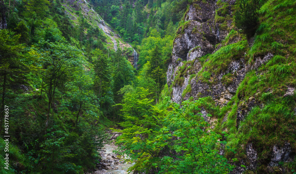 Fototapeta premium Sankt Gilgen waterfall in Austrian Alps, klausbach valley near attersee. Long exposure