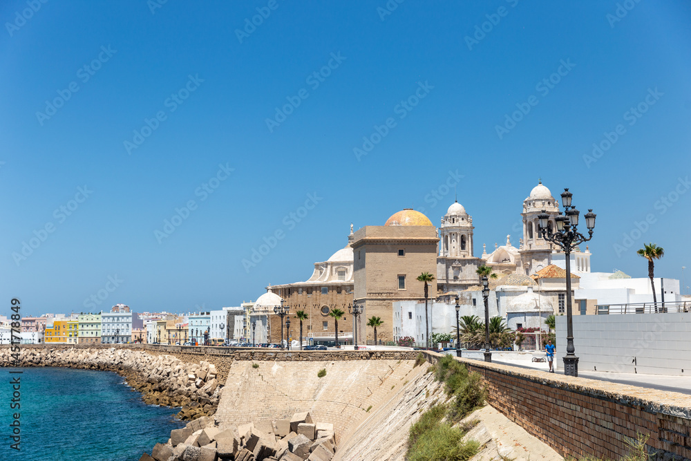 View of Cathedral Of Cadiz. Panoramic view of the city with promenade area and Mediterranean sea. Touristic travel destination in South of Spain. 