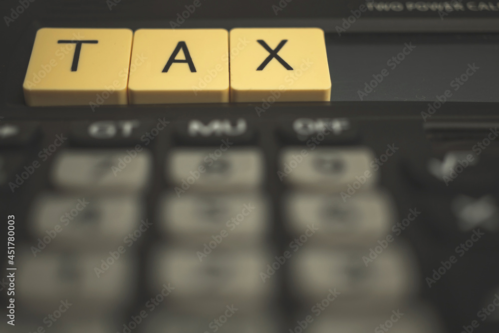 Concept of TAX season with wooden blocks and calculator, business 1040 background photo Concept of TAX season with wooden blocks and calculator, business 1040 background photo