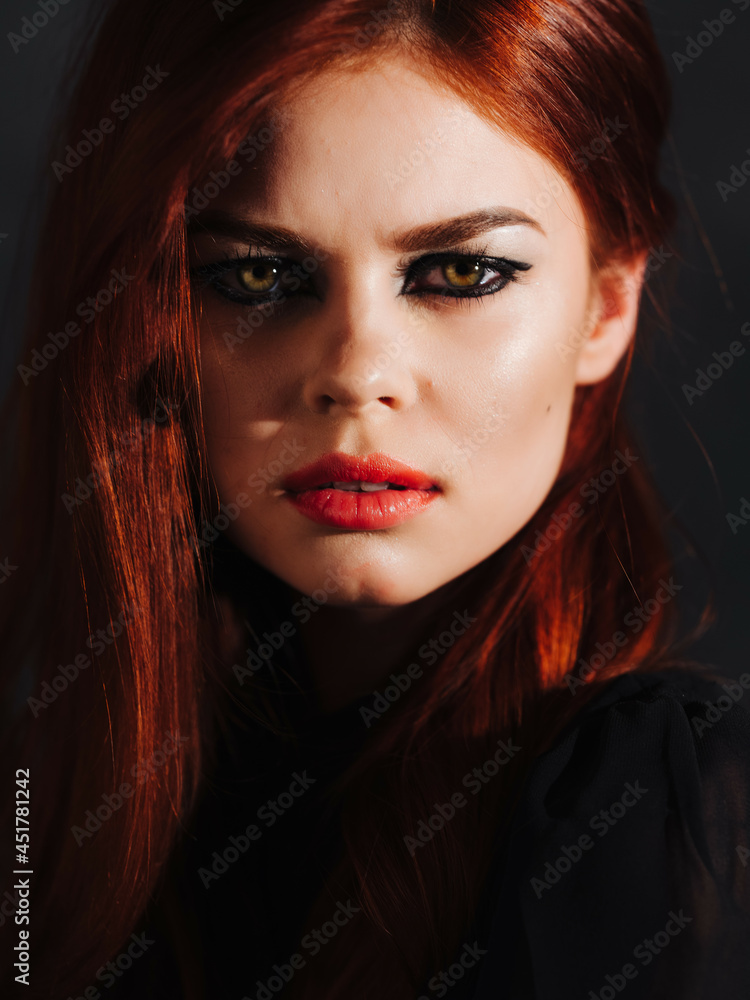 woman with makeup on her face red lips charm face close-up dark background